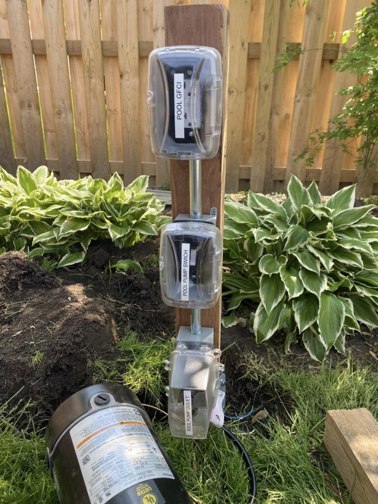 Weatherproof electrical boxes installed near residential pool equipment