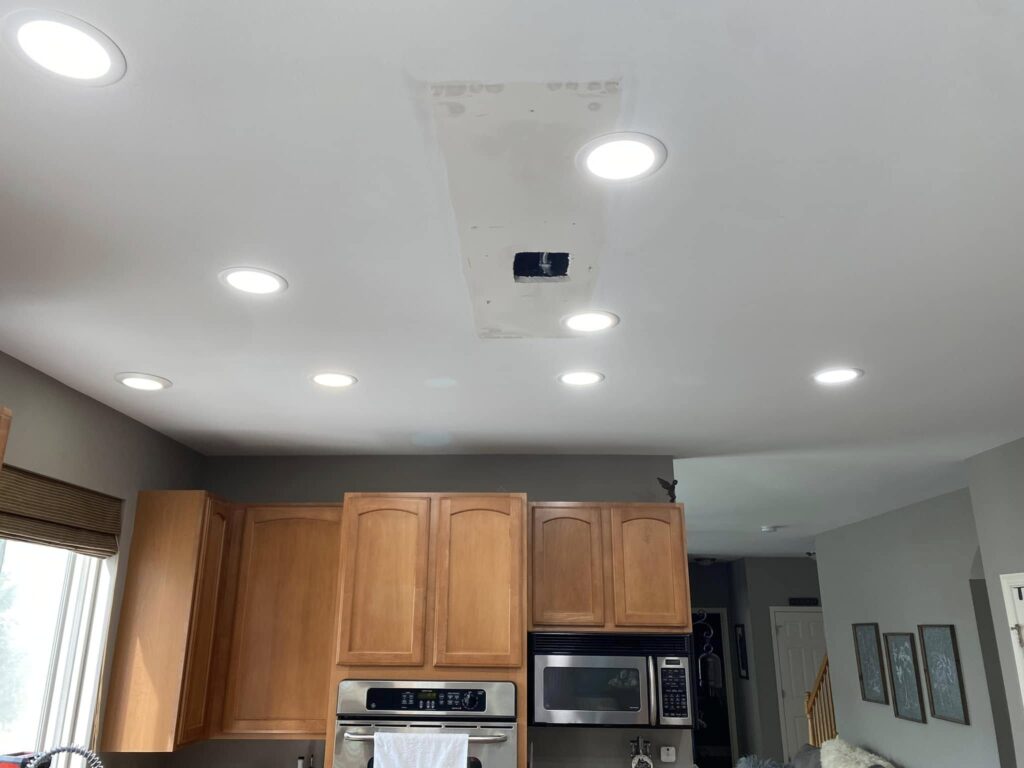 Recessed ceiling lights installed throughout a residential kitchen