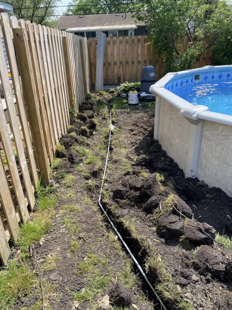 Underground electrical conduit routed alongside an above-ground pool